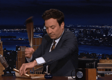 Animated GIF of Jimmy Fallon writing notes at a desk